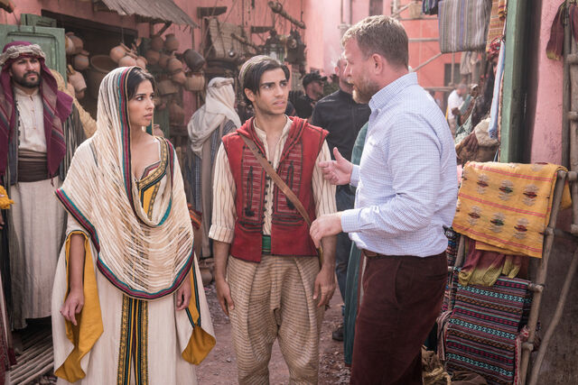 Naomi Scott and Mena Massoud on set with director Guy Ritchie.