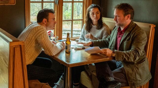 Chris Evans and Ana de Armas wearing sweaters, Rian Johnson not wearing a sweater, on the set of Knives Out.