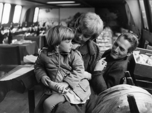 Nell, the eldest child of Woodward and Newman, on location with her parents during filming of Paris Blues (1961).
