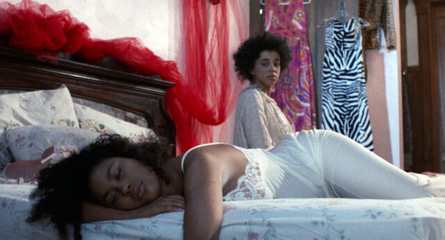 Alma Gold (Kim Weston-Moran) watching over her sleeping child Rainbow (Victoria Gabrielle Platt) in Alma’s Rainbow (1994).