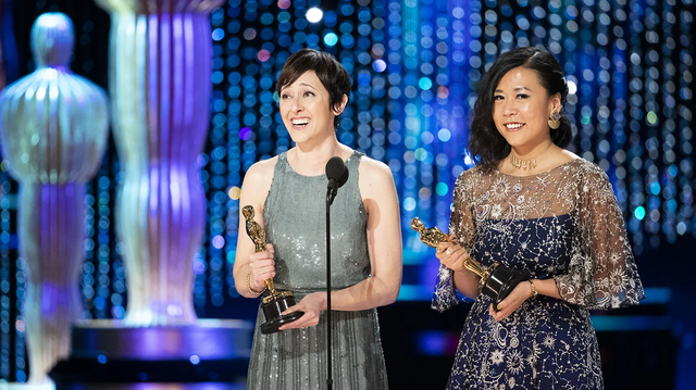 Producer Becky Neimann-Cobb and writer-director Domee Shi with their Oscars for Bao (2018).