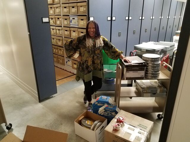 Filmmaker Ayoka Chenzira surrounded by negatives and prints as she prepares to ship her work to Mark Toscano at the Academy Film Archive.