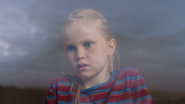 Ida, peering out from her secret world.