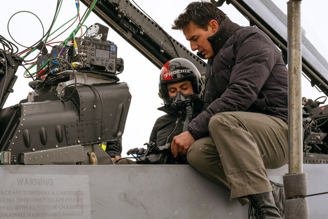 Monica Barbaro (Natasha ‘Phoenix’ Trace) and Tom Cruise on the Top Gun: Maverick set.
