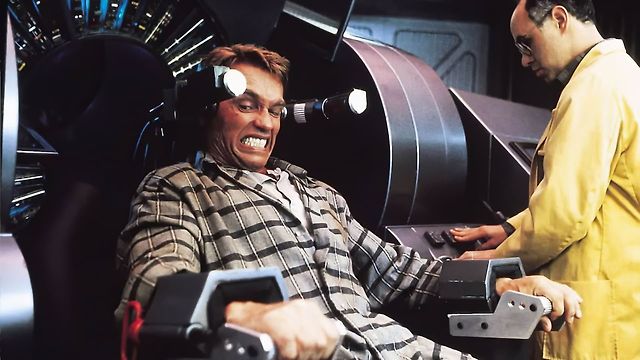 Arnold Schwarzenegger strapped into the recording chair.