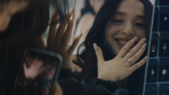 Ani shows off her new wedding ring.