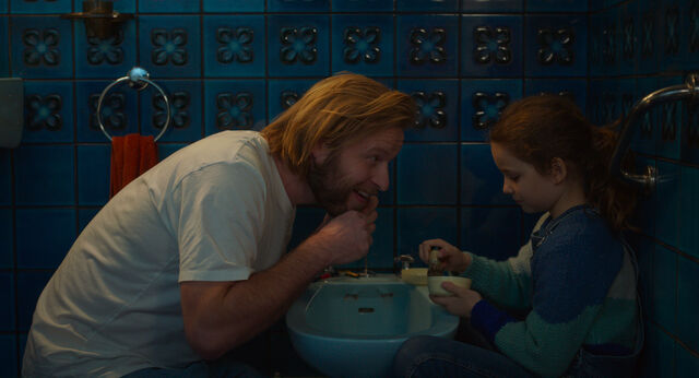 Nelly helps her father (Stéphane Varupenne) to shave.