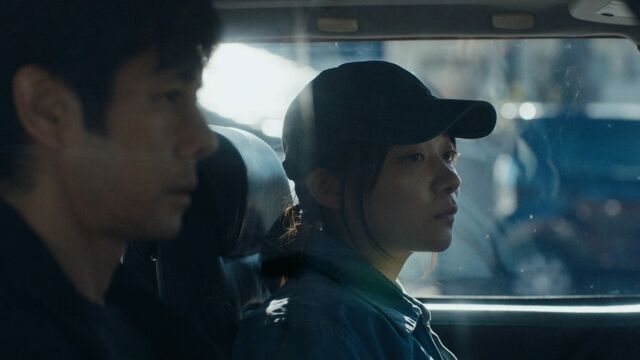 Hidetoshi Nishijima and Toko Miura on the road in Drive My Car.