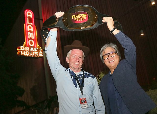 Alamo Drafthouse and Fantastic Fest co-founder Tim League with Director Park and his 2022 Lifetime Achievement Award—a bespoke wrestling championship belt.
