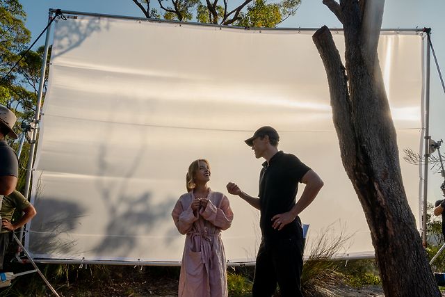 Will Gluck making sure to get the right light with Sydney Sweeney.  — Credit… Sony Pictures