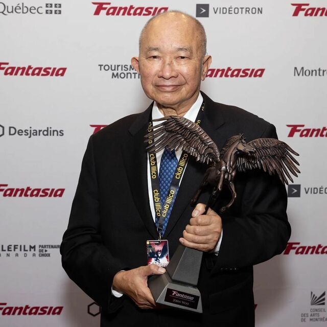 John Woo with his Career Achievement Award at the 2022 Fantasia International Film Festival.