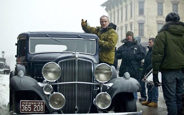 Mann catches a ride on the set of Public Enemies (2009). — Credit… Universal Pictures